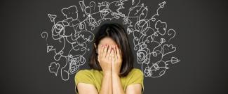 A woman with her head in her hands, her mind in chaos, having many thoughts at once